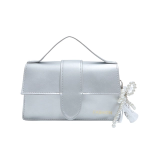 Silver metallic shoulder bag with pearl lace pendant and top handle, elegant box style