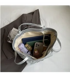 Macro view of silver tote bag interior with multiple compartments for daily items
