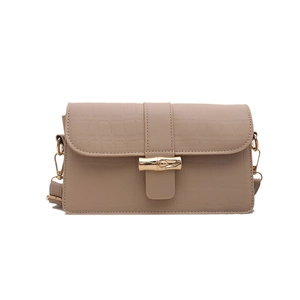Elegant beige crocodile texture shoulder bag with distinctive golden bamboo clasp lock