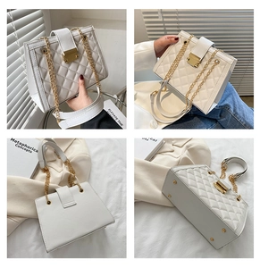 Detail view of cream quilted shoulder bag with gold chain and rectangular twist lock