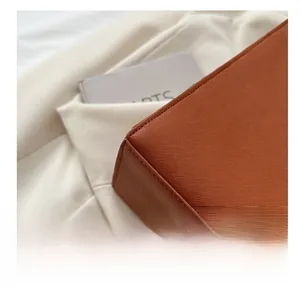 Detailed macro shot of brown crossgrain leather with precision stitching on tote bag