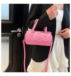 Pink heart quilted cylindrical handbag with silver bow detail and dual handles