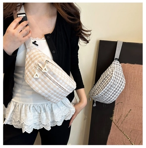 Close-up of beige and gray plaid crossbody bags with adjustable straps and zipper detail