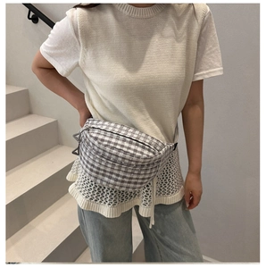Close-up of grey and white checkered waist bag featuring double zipper details