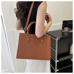 Brown leather business tote bag shown as a crossbody purse on a model back view