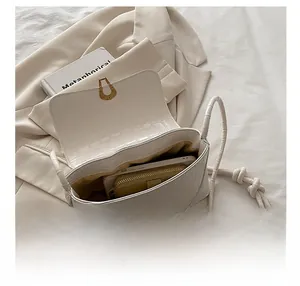Internal view of the white crocodile-patterned bag showing its spacious capacity