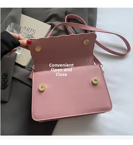 Detail of pink crossbody bag showing wave-edge flap and dual magnetic snap closure