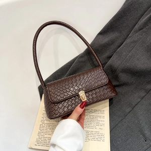 Brown woven baguette bag with a gold lock and shoulder strap for elegant women fashion