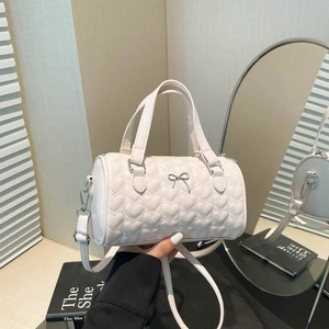 Beige Boston bag with heart quilting and silver bow detail for elegant women