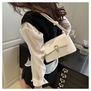 White crocodile pattern crossbody bag featuring golden hardware and adjustable strap
