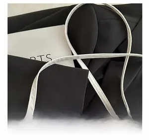 Detail of adjustable white crossbody strap and star buckles on the PU leather bag