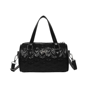 Black heart-quilted cylinder handbag with top handle and silver bow detail