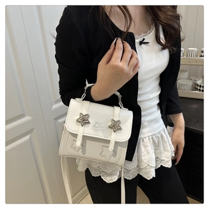 Detailed side view of white square crossbody bag with silver star rivets and embossing
