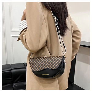 Detailed view of saddle bag featuring a black leather trim and geometric pattern