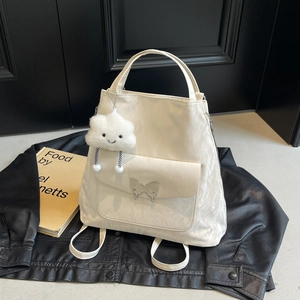 White butterfly buckle tote with pleated texture and cloud charm on black background