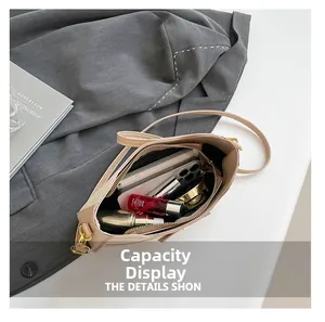 Interior view of beige shoulder bag showing large capacity for phone and cosmetics