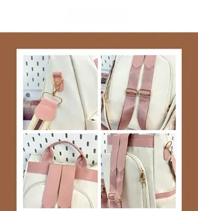 Detail view of pink adjustable shoulder straps and gold metal hooks on a nylon backpack
