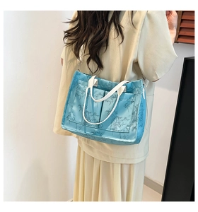 Detail of light blue tote bag with bamboo leaf pattern and adjustable shoulder strap