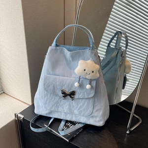Blue pleated texture backpack with metallic butterfly buckle and cloud charm accessory