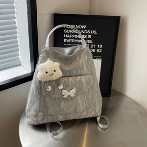 Silver wrinkled leather tote bag with metal butterfly buckle and cloud charm