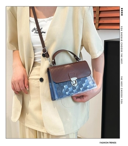 Detail of blue transparent jelly bag with diamond texture and brown leather strap