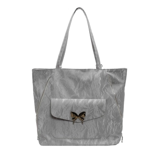 Minimalist silver metallic tote bag with gold butterfly clasp and zipper details