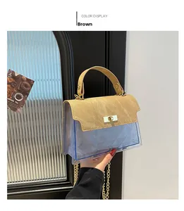 Detail of blue quilted PVC bag with brown leather flap and golden twist lock closure