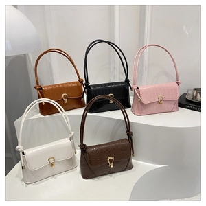 Detail showing five colors of crocodile pattern shoulder bags with gold buckles