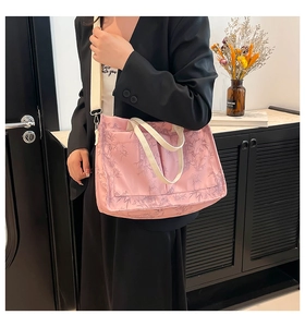 Pink canvas tote bag featuring purple bamboo prints and two front pockets detail