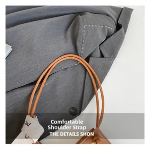 Detail of vintage brown tote bag featuring dual leather and woven decorative straps