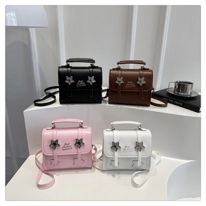 Detailed view of four colorful mini handbags with star motifs and top handles
