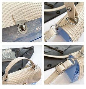 Detail of silver clasp and accordion pleats on a transparent jelly bag with blue accents