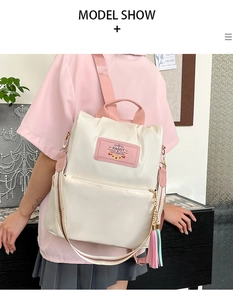 Detail of oxford backpack showing pink tassels, brand label, and pastel color matching