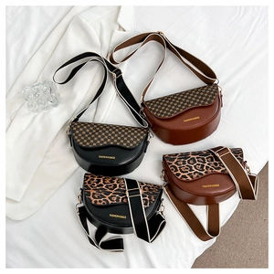 Detail of four retro saddle bags with checkerboard and leopard print flaps and wide straps