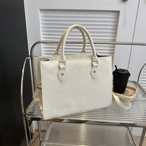 Structured white Saffiano tote bag with top handles and gold hardware for business