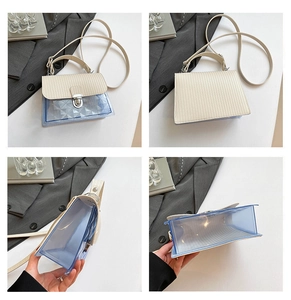 Detail view of the cream leather texture and blue transparent PVC on this modern handbag