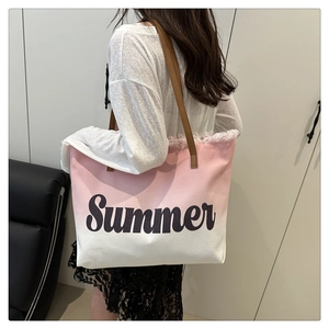 Detail of pink gradient canvas tote bag featuring Summer print and tassel edges