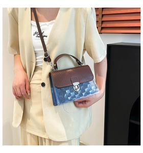 Detail of blue transparent jelly bag with embossed patterns and silver metal lock