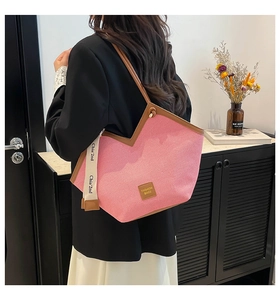 Pink corduroy tote bag detail with brown leather trim and fashion brand tag ornament
