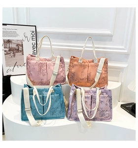 Detail view of large tote bags with bamboo leaf print in pink, orange, blue and violet