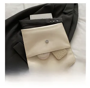 Internal view of cream rhinestone envelope bag showing storage capacity for cosmetics