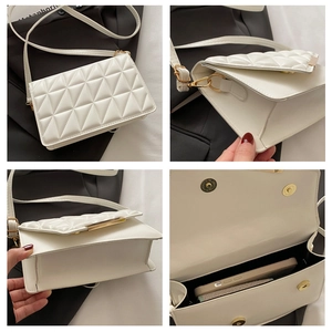 Detail view of white quilted crossbody bag with gold metallic buckle and compact interior