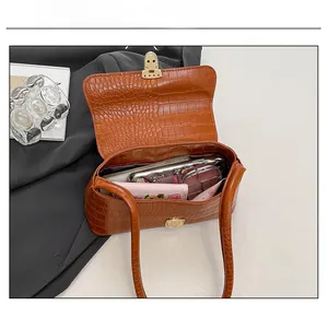 Detail view of brown crocodile embossed shoulder bag interior showing large capacity