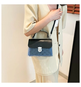 Detail of a black and transparent blue jelly bag with metal lock and textured PVC