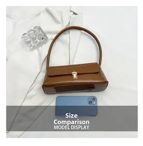 Brown patent leather baguette bag size comparison with a smartphone and metal buckle