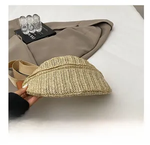 Detailed close-up of woven straw chest bag showing the wide durable base and texture