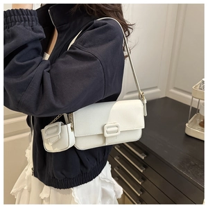 Detail of white lychee leather shoulder bag with matching mini coin purse and gold chain