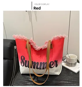 Detail of red gradient canvas tote with pink fringe trim and Summer text print