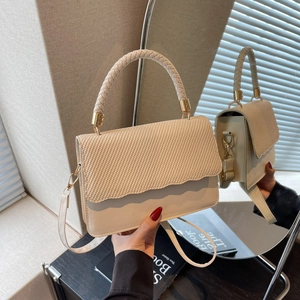 Beige woven leather crossbody handbag with gold hardware and stylish top handle