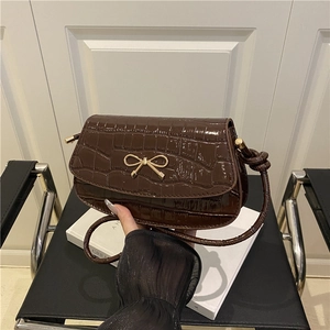 Dark brown faux crocodile leather underarm bag with a golden bow knot and glossy finish